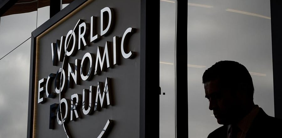 In this file photograph taken on January 21, 2019, a participant at the World Economic Forum (WEF) annual meeting is seen in silhouette at the Congress Centre in Davos, eastern Switzerland. (AFP)
