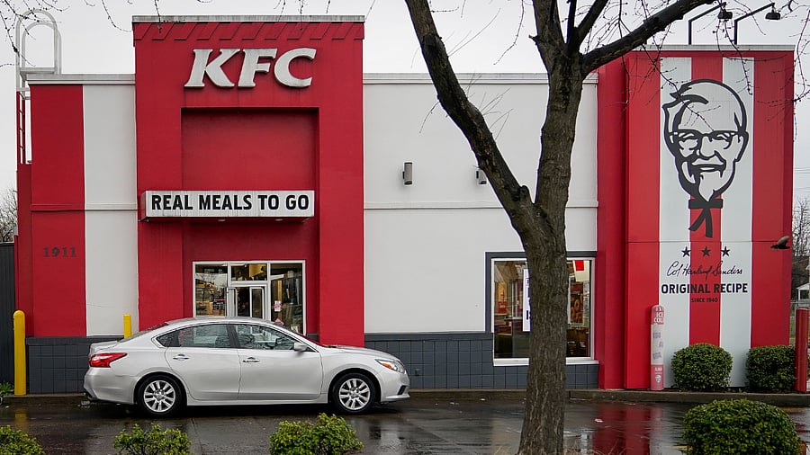 A vehicle waits at the drive-thru window of Kentucky Fried Chicken. Credits: Reuters Photo