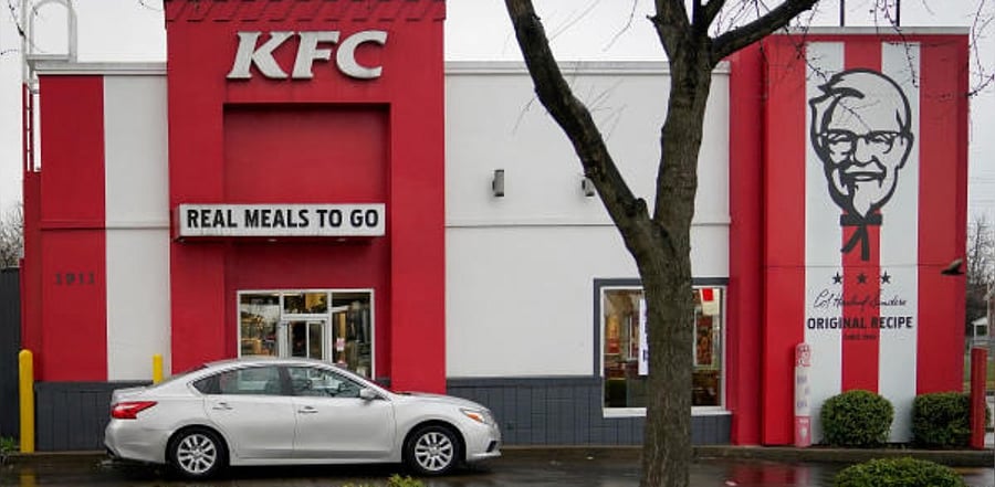 A vehicle waits at the drive-thru window of a Kentucky Fried Chicken (KFC). Credit: Reuters Photo