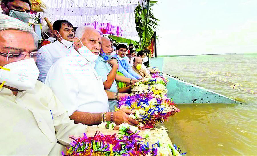 Chief Minister B S Yediyurappa offers bagina at Lal Bahadur Shastri reservoir in Almatti, Vijayapura district on Tuesday. Deputy Chief Minister Govind Karjol is also seen.