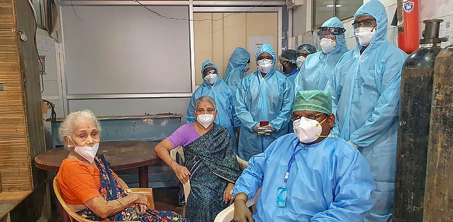 94-year-old Gowri (L) and her 71-year-old daughter Jayalakshmi (C) discharged from a private hospital after completely recovering from Covid-19, in Chennai. Credit: PTI Photo