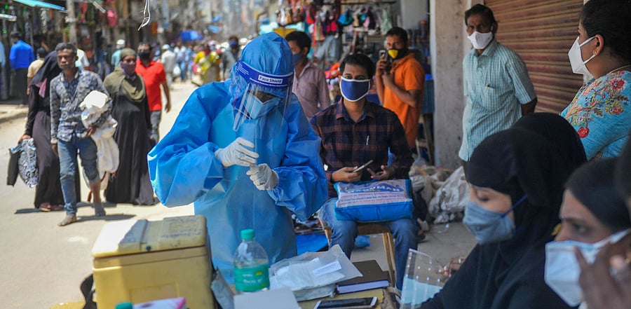 A medic wearing PPE kit while collecting samples for Covid-19 tests, in Bengaluru. Credit: PTI Photo