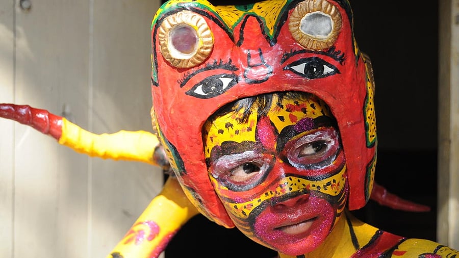 Hindus and Muslims get themselves painted with tiger stripes during Muharram. DH Photos by Tajuddin Azad