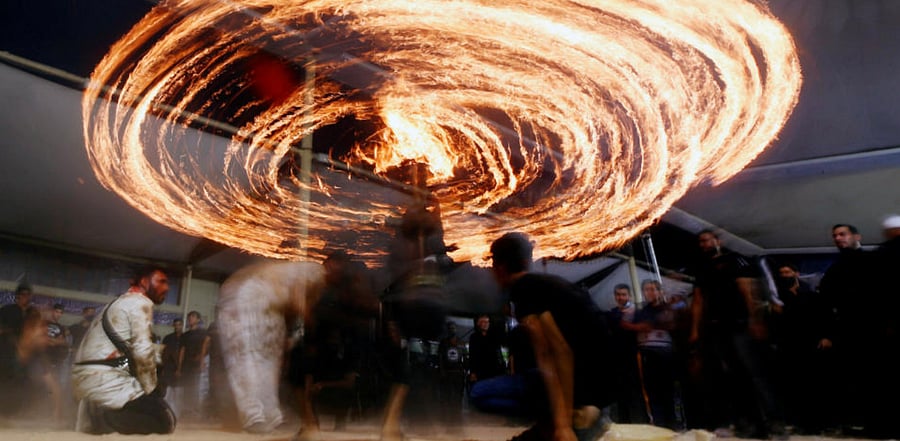 Shi'ite Muslims perform with fire during commemorations of Ashura, amid the spread of the coronavirus disease, in the holy city of Najaf. Credit: Reuters