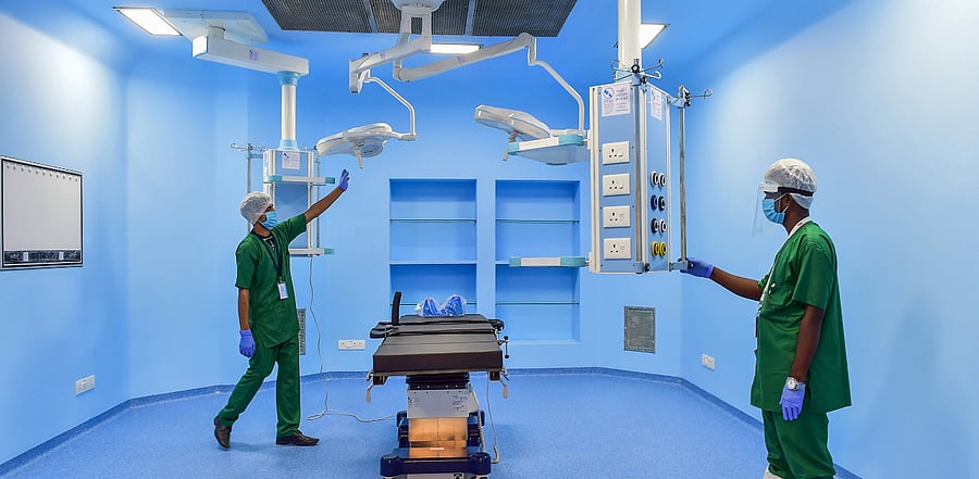 Workers prepare an OT at an ICU ward, especially for Covid-19 patients, during its inauguration in Bengaluru. Credit: PTI Photo