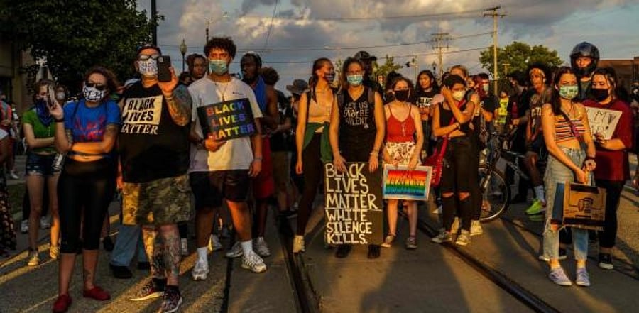 protestors stand on a road during a march against the shooting of Jacob Blake in Kenosha, Wisconsin. Credit: AFP Photo