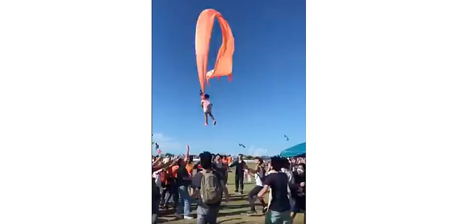 A 3-year-old girl is lifted into the air by a large kite during a kite festival in Hsinchu, northern Taiwan. Credit: AP Photo