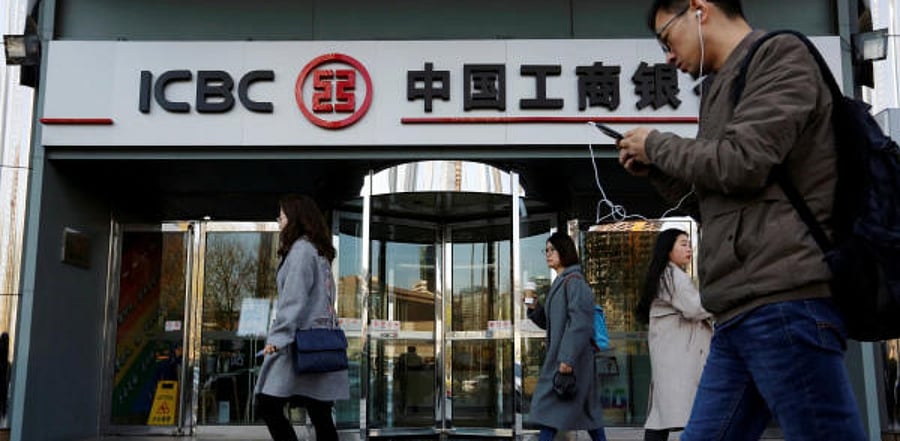 People walk past a branch of Industrial and Commercial Bank of China (ICBC) in Beijing, China. Credit: Reuters Photo