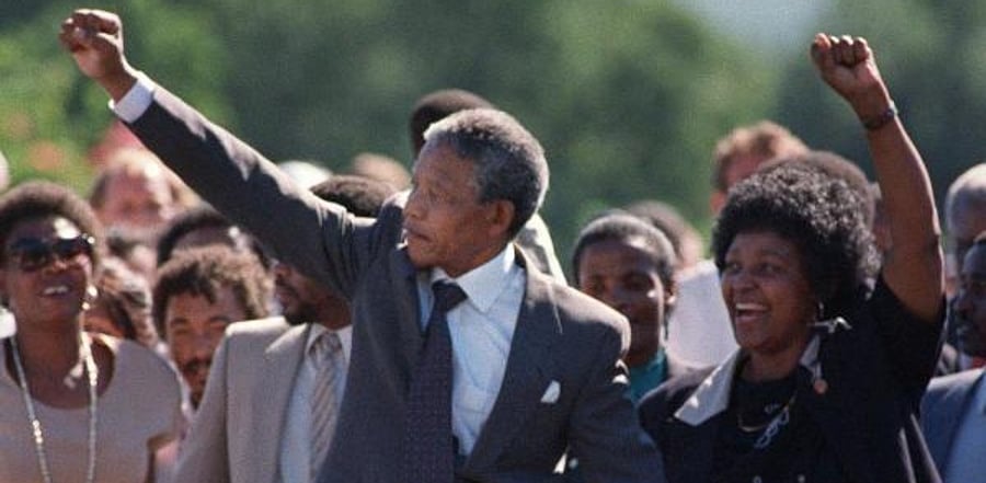 Nelson Mandela (L) and his wife Winnie raising their fists and saluting cheering crowds. Credit: AFP