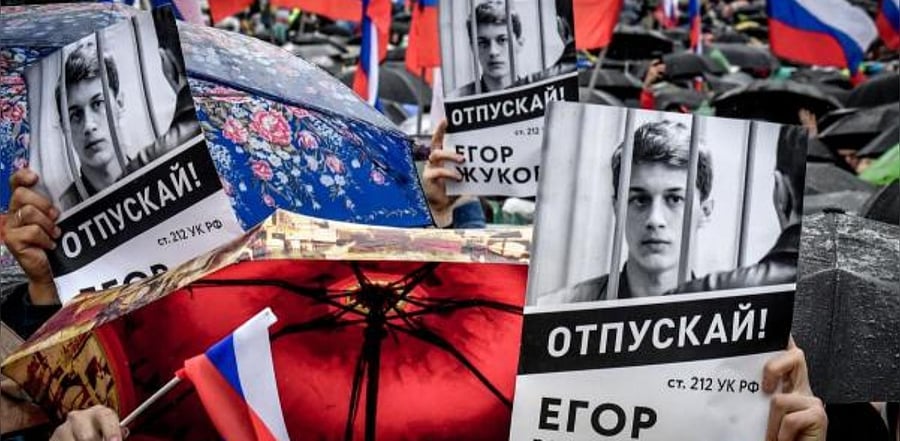 Protesters hold posters reading "Free (jailed student) Yegor Zhukov!" during a rally in central Moscow. Credit: AFP
