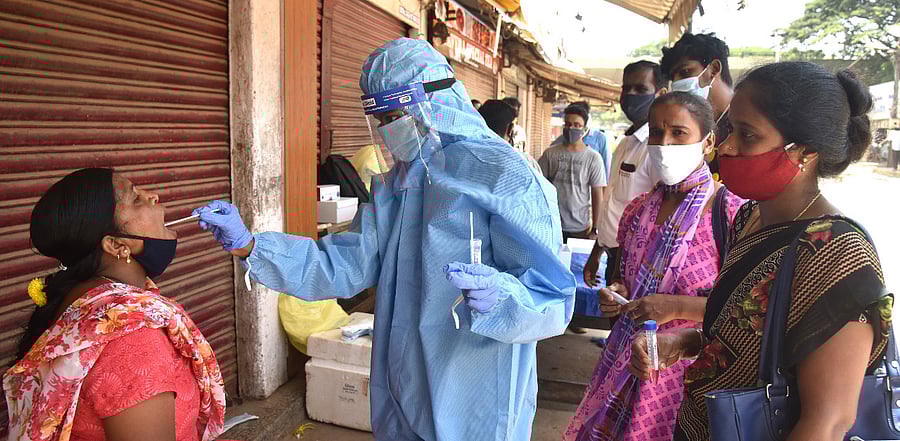 Health Staff collecting nasal swab for coronavirus test. Credit: DH Photo