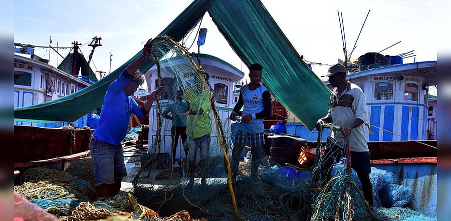 Fishermen readying the nets for deep sea fishing at fisheries harbour in Mangaluru. DH Photo/Govindraj Javali