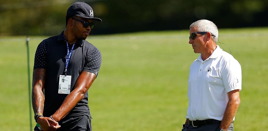 PGA Tour commissioner Jay Monahan and Kent Bazemore converse. Credits: AFP