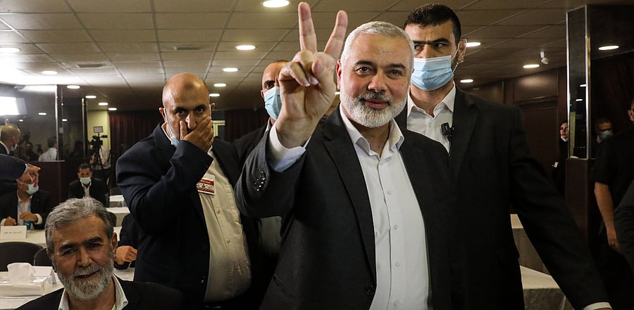 Hamas chief Ismail Haniyeh (front) flashes the victory gesture upon arriving for a meeting with representatives of other Palestinian factions. Credit: AFP Photo