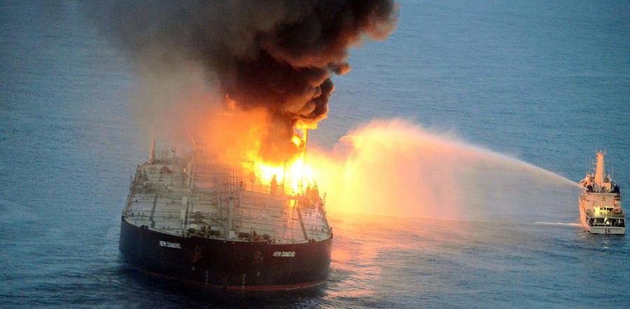 Indian coast guard ship (R) battling to extinguish the fire from the Panamanian-registered crude oil tanker New Diamond, some 60 km off Sri Lanka's eastern coast. Credit: AFP Photo