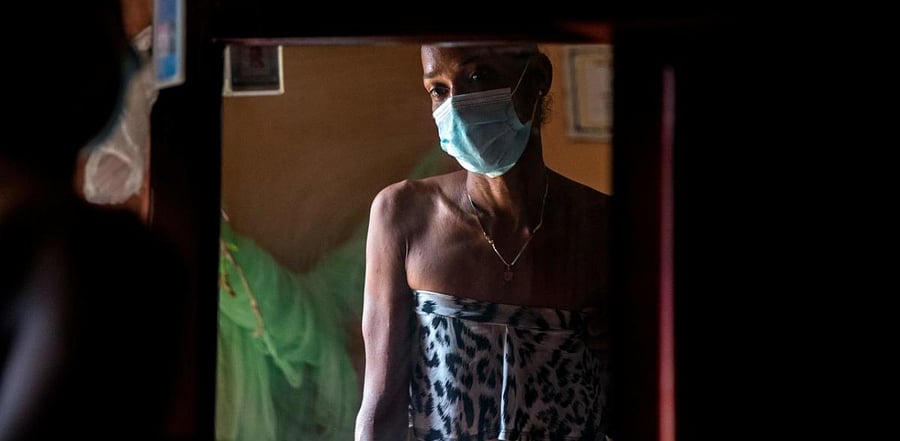 Dominican transgender woman Yohana Espinoza, 37, a sexual worker, is reflected on a mirror at her house in Santo Domingo. Cedits