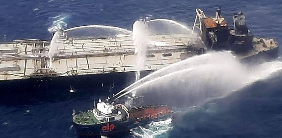 This handout photograph taken on September 6, 2020, and released by Sri Lanka's Air Force shows fireboats battling to extinguish a fire on the Panamanian-registered crude oil tanker New Diamond, some 60 km off Sri Lanka's eastern coast where a fire was reported inside the engine room. 
