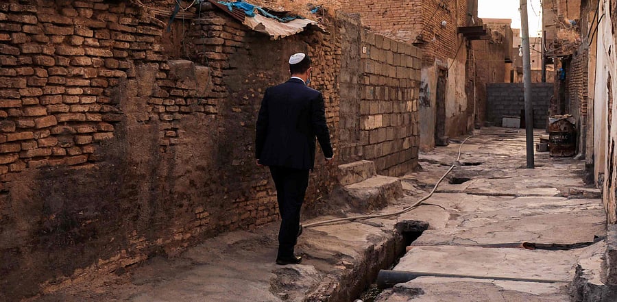 Ranj Abderrahman Cohen, an Iraqi Kurdish Jewish man, walks next to a ruined Jewish synagogue in Arbil, the capital of the autonomous Kurdish region of northern Iraq. Credit: AFP Photo