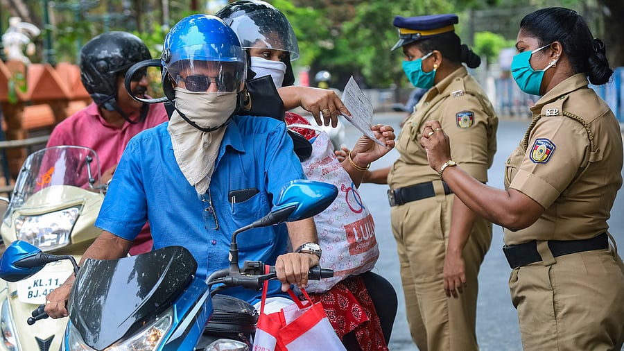 Police personnel question commuters who defied curfew during a 21-day nationwide lockdown, in the wake of coronavirus. Credits: PTI Photo