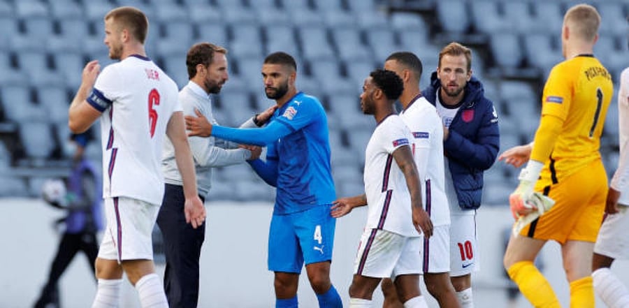 England's Harry Kane with teammates as England manager Gareth Southgate shakes hands with Iceland's Victor Palsson after the match. Credit: Reuters Photo