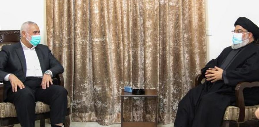 Hassan Nasrallah (R), the head of Lebanon's militant Shiite movement Hezbollah, meeting with Hamas' political bureau chief Ismail Haniya (L) at an undisclosed location. Credit: AFP Photo