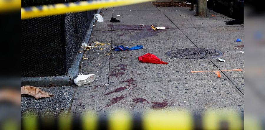 A blood stained sidewalk and clothing are seen behind NYPD police tape, where according to local media reports five people were shot, including a 6-year-old boy, early Monday during an outdoor J’Ouvert celebration, in the Crown Heights section Brooklyn in New York, US, September 7, 2020. Credit: REUTERS Photo