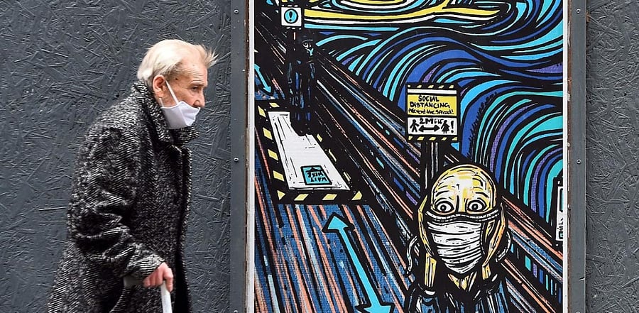 An elderly pedestrian wearing a face mask or covering due to the Covid-19 pandemic. Credit: AFP