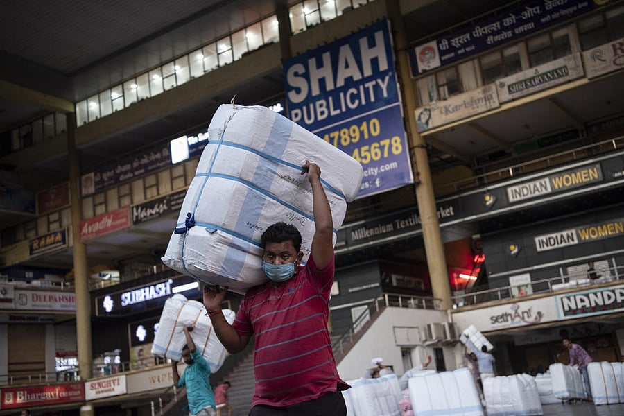Bundles of fabric at a textile market in Surat, India. The New York Times