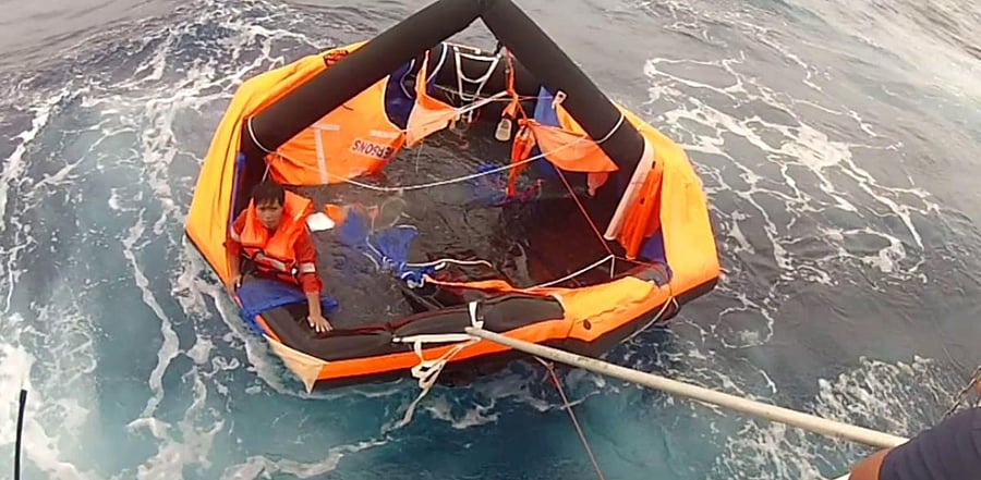 Filipino crew member being rescued from a life raft by Japanese coast guards on September 4. Credit: AFP Photo