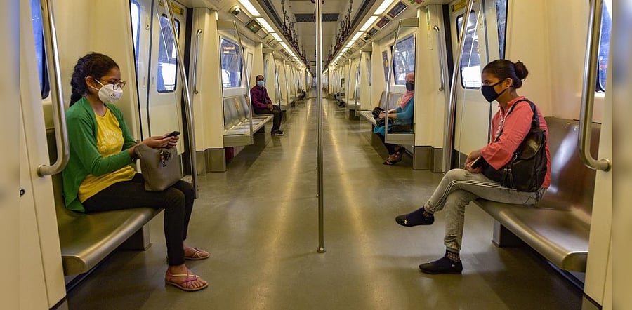 Commuters board a metro train at Vaishali station following resumption of services on the Blue and Pink Line in a graded manner, after being closed for over five months due to coronavirus pandemic, in Ghaziabad. Credit: PTI Photo