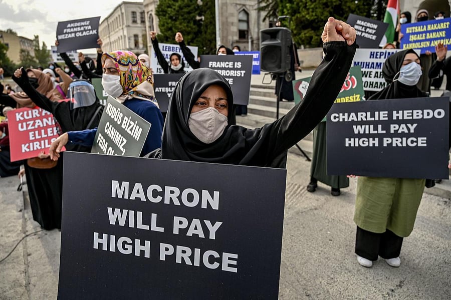 Protesters chant slogans and hold signs against France and the French President in Istanbul. Credit: AFP
