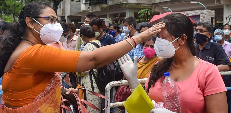 A National Eligibility-cum-Entrance Test (NEET) aspirant seeks blessings from her mother outside an examination centre, in Kolkata. Credit: PTI