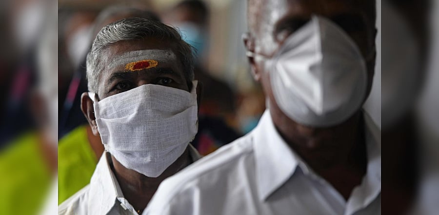 Commuters line up to board a special train at Egmore railway station after the government eased a nationwide lockdown imposed as a preventive measure against the Covid-19 coronavirus, in Chennai on September 8, 2020. Credit: AFP Photo