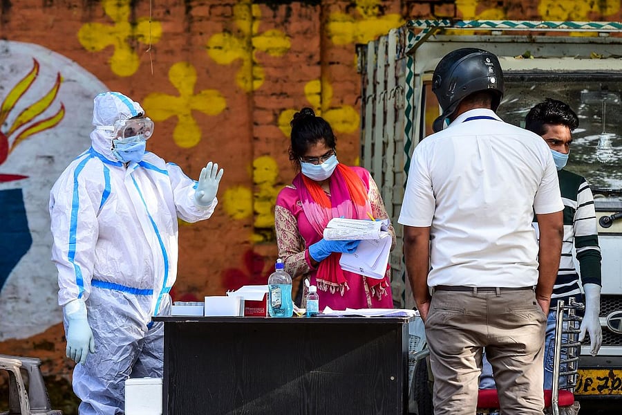 Pedestrians line up to get tested for the novel coronavirus. Credit: AFP