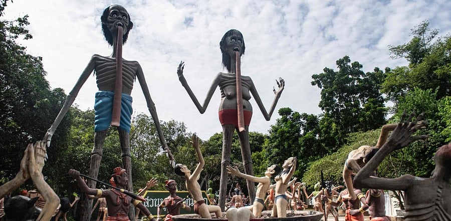 A dragon encircles a tower, wretched souls face torture, superheroes scale a mosiac wall -- these may seem like scenes from a half-remembered dream, but are in fact famed temples in Thailand. Credit: AFP Photo