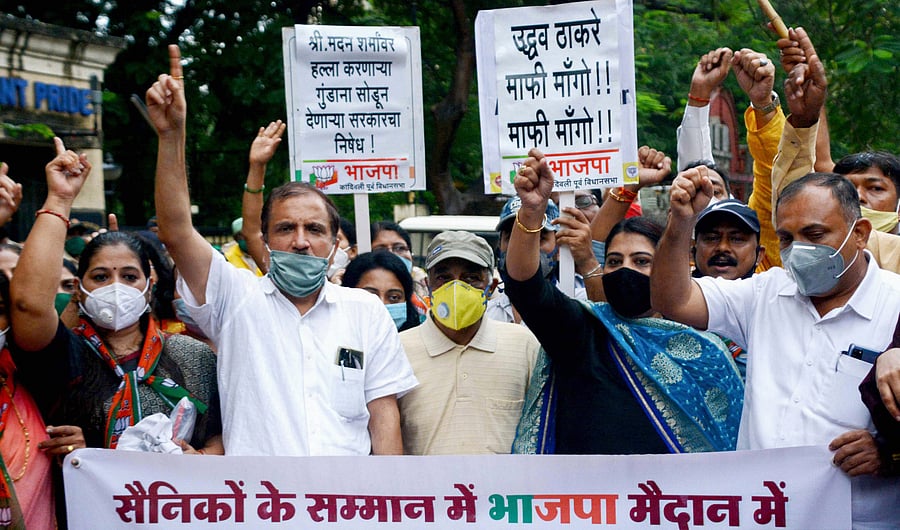 Bhartiya Janta Party activists and ex-navy officer Madan Sharma stage a protest against Shiv Sena party workers. Credits: PTI Photo