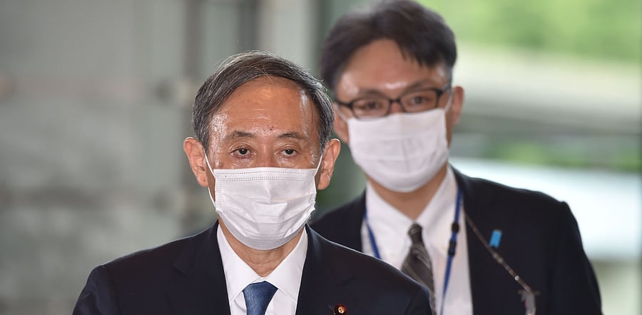 Japan's new Prime Minister Yoshihide Suga (L) arrives at his office in Tokyo on September 16, 2020. Credit: AFP Photo
