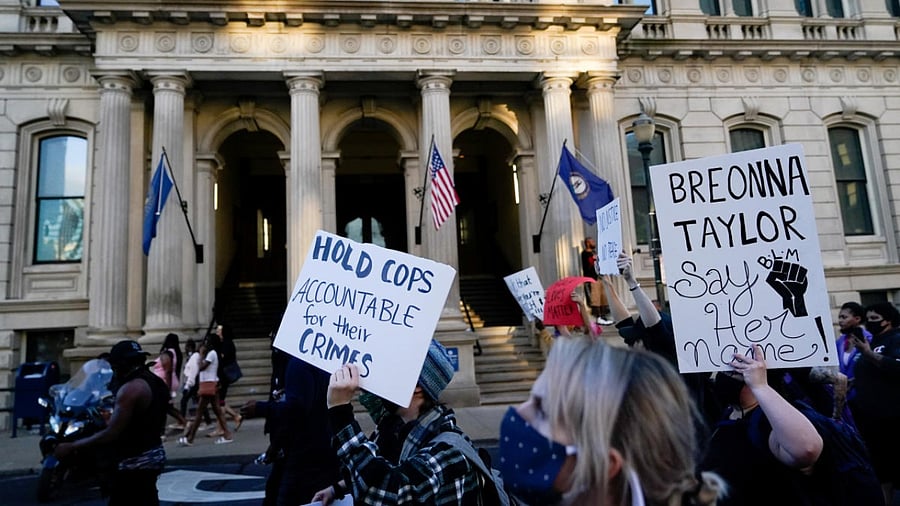 People march past City Hall during a protest against the deaths of Breonna Taylor by Louisville police and George Floyd by Minneapolis police, in Louisville. Credit: Reuters/file photo