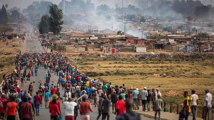 In this file photo taken on September 05, 2019 A mob armed with spears, batons and axes run through Johannesburg's Katlehong Township during a new wave of anti-foreigner violence. Credit: AFP