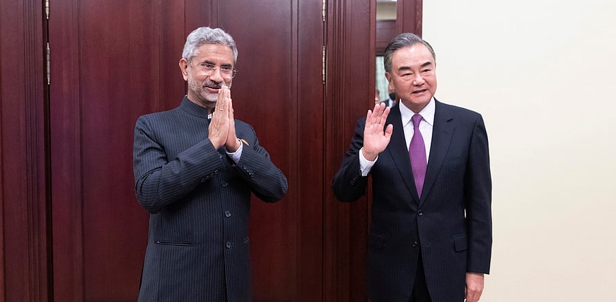 India's External Affairs Minister Subrahmanyam Jaishankar, left, and Chinese Foreign Minister Wang Yi pose for a photo as they meet on the sidelines of a meeting of the foreign ministers of the Shanghai Cooperation Organization. Credit: AP Photo