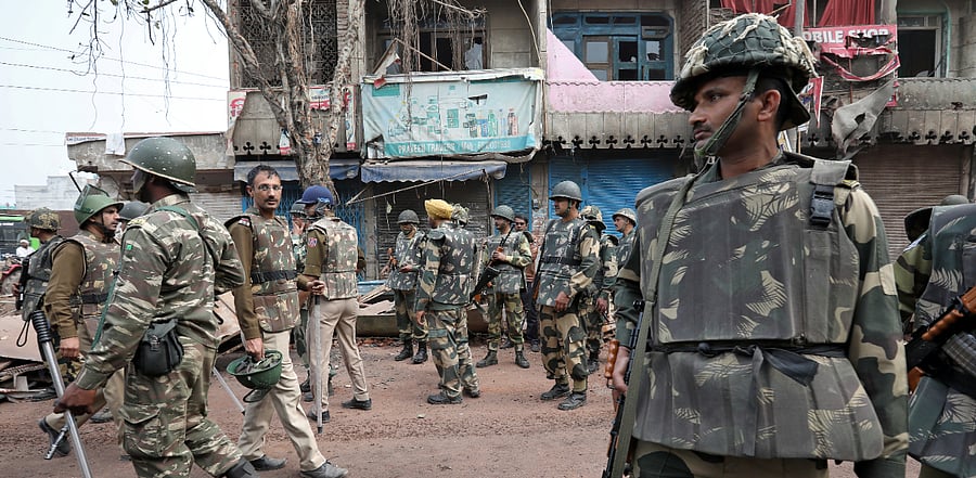 Police stand guard in a riot affected area following clashes between people demonstrating for and against a new citizenship law in New Delhi, February 28, 2020. Credit: Reuters Photo