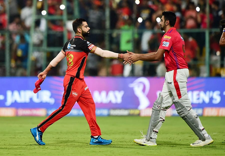RCB skipper Virat Kohli greets his KXIP counterpart Ravichandran Ashwin after beating Kings XI Punjab during the Indian Premier League 2019 (IPL T20) cricket match at Chinnaswamy Stadium in Bengaluru. (PTI Photo)