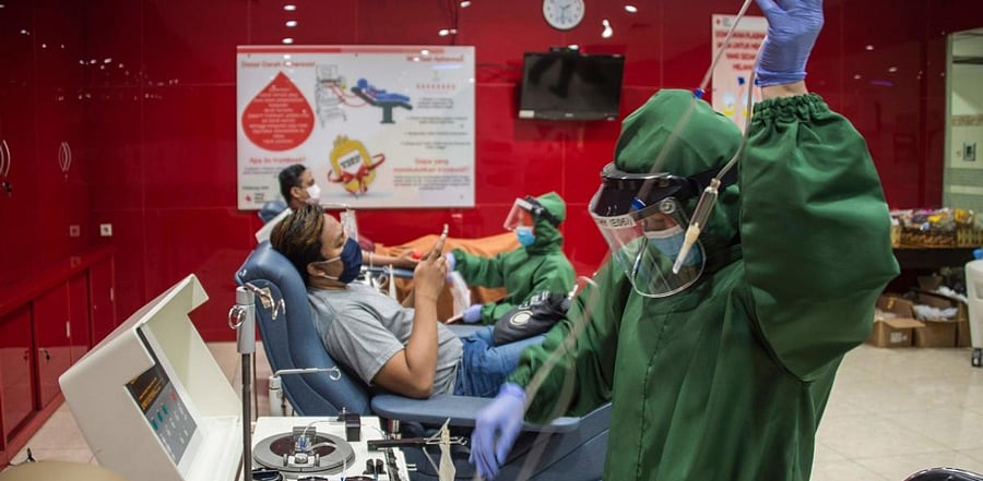 The researchers built a model that simulates the probability of getting infected by Covid-19, the probability of dying from it, and the probability of dying from another cause for a period of one year, taking into account the different fatality rates from the disease for different age groups. Credit: AFP