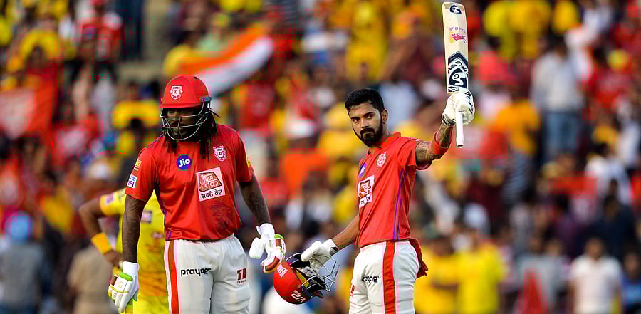 Kings XI Punjab cricketer KL Rahul (R) raises his bat after he scored half century (50 runs) during the 2019 Indian Premier League (IPL) Twenty20 cricket match between Kings XI Punjab and Chennai Super Kings at the Punjab Cricket Association Stadium in Mohali. Credit: AFP File Photo