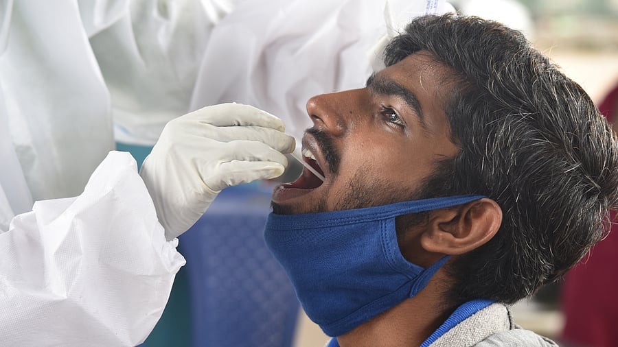 Medical staff collecting swab for Coronavirus test. Credits: DH Photo