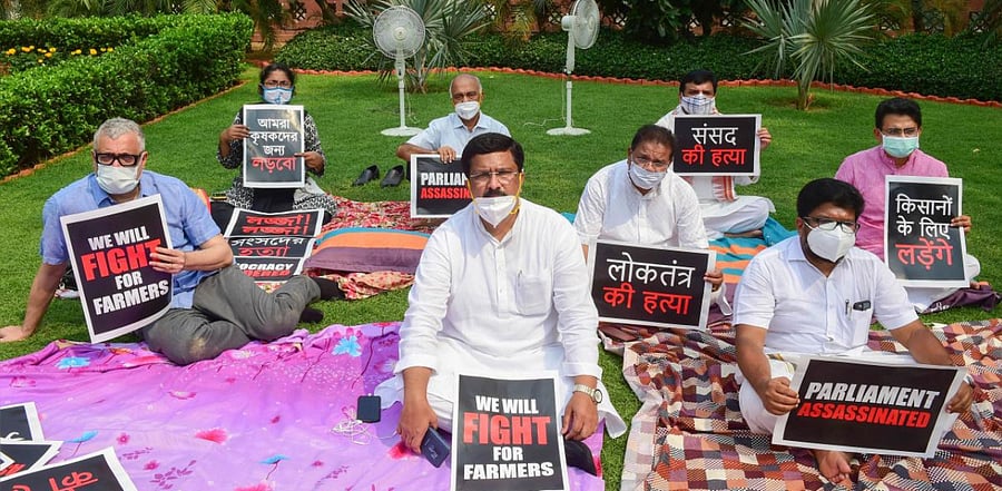 Eight suspended Rajya Sabha MPs display placards as they stage a protest over their suspension, during ongoing Monsoon Session of Parliament. Credit: PTI