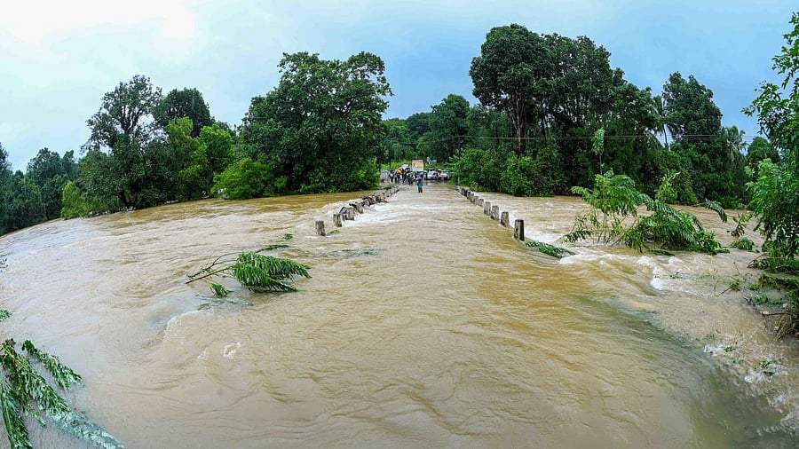 Water flows on a bridge that connects Perdoor-Harikhandige at Annalu.
