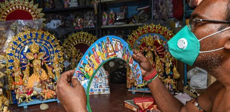 An artisan gives a finishing touch to an idol of Goddess Durga for the upcoming Durga Puja festival, at Kumartuli in Kolkata. Credit: PTI Photo