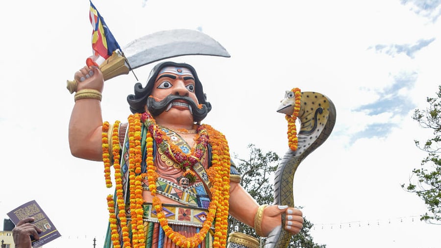 Members of Dalit Welfare Trust and University of Mysore Research Students’ Federation pay tributes to the statue of Mahishasura as part of Mahisha Dasara, atop the Chamundi Hill in 2017. DH File Photo