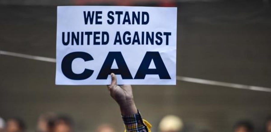 A protestor holds a placard during a demonstration against the Citizenship Amendment Act (CAA) at Jamia Nagar in New Delhi, Friday, Dec. 20, 2019. Credit: PTI Photo